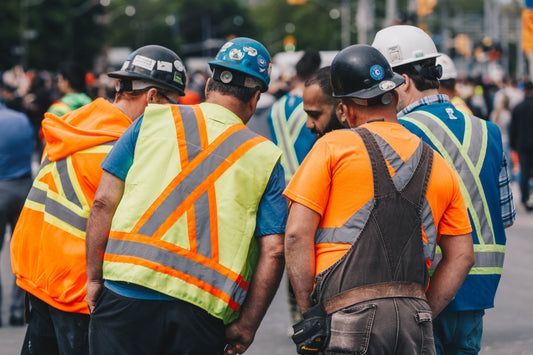 Construction crew in branded safety uniforms—showcasing how Inkdnylon Custom Apparel helps small businesses boost team visibility, professionalism, and trust through custom workwear.
