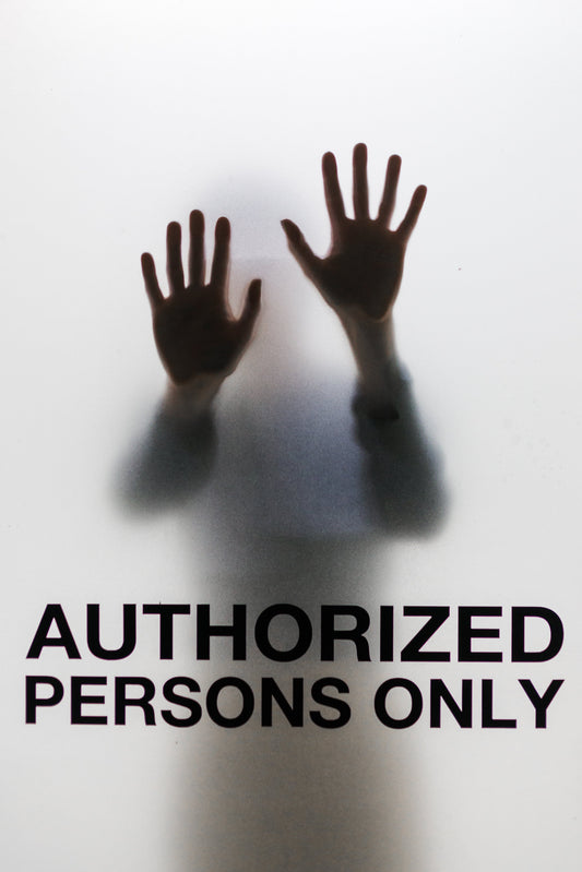 Silhouette behind glass marked “Authorized Persons Only”—emphasizing why staff uniforms from Inkdnylon Custom Apparel help teams quickly identify who belongs and boost workplace safety.